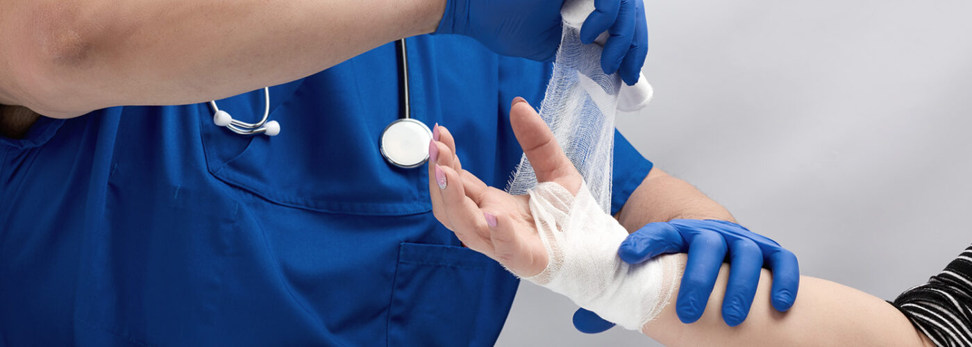 Medical professional wrapping person's wrist